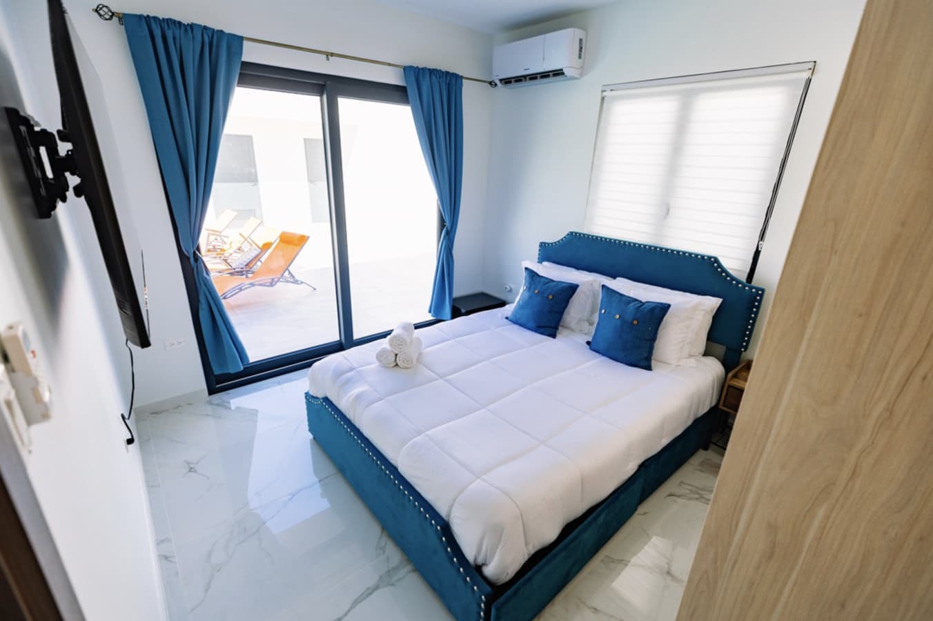 Bedroom with pool view and blue accents