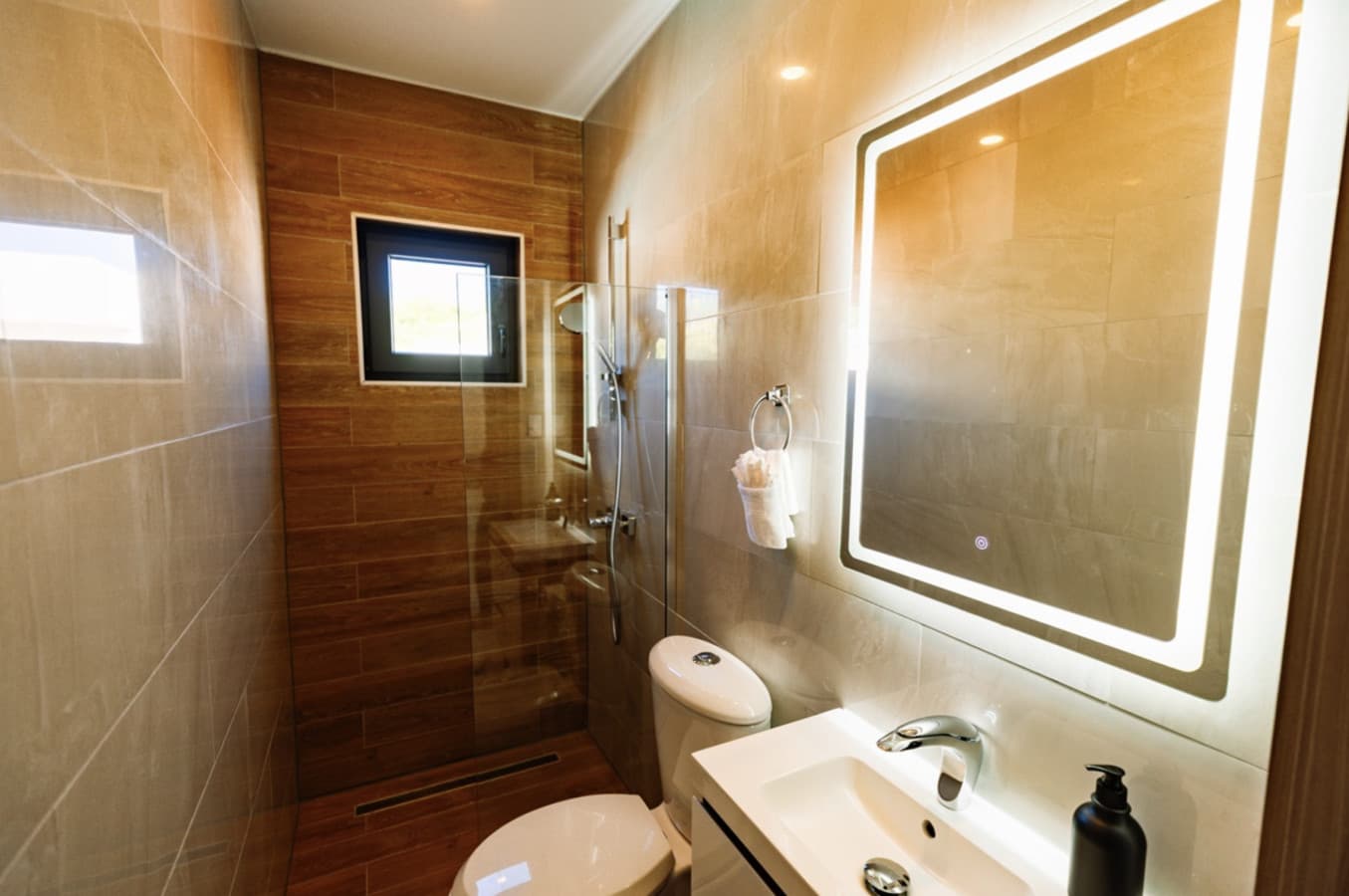 Spa-like bathroom with backlit mirror