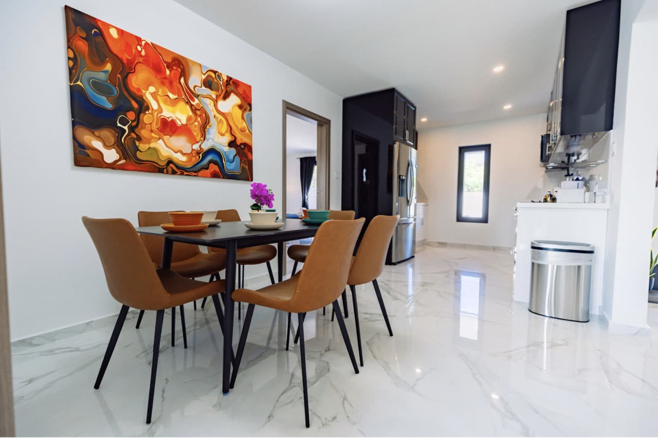 Dining area with modern art and kitchen